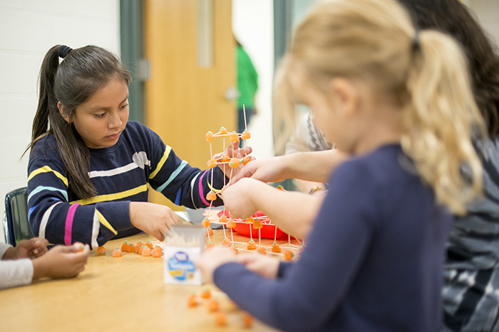 Girl Building Tower with Gumdrops